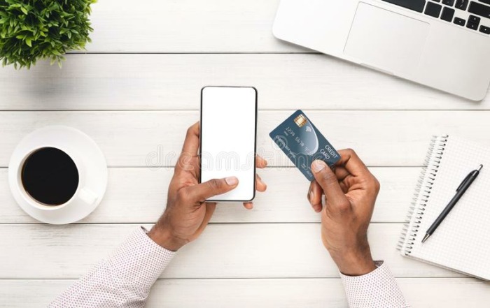 internet-banking-smartphone-blank-screen-credit-card-hands-unrecognizable-african-american-man-sitting-workplace-161286464