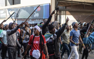 Armed protesters march in Alexandra, near Johannesburg, on 16 July. Photograph: Emmanuel Croset/AFP/Getty Images